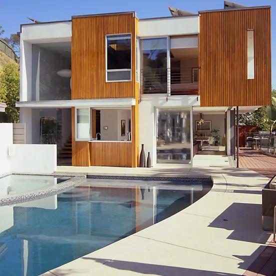 A large pool in front of a house.